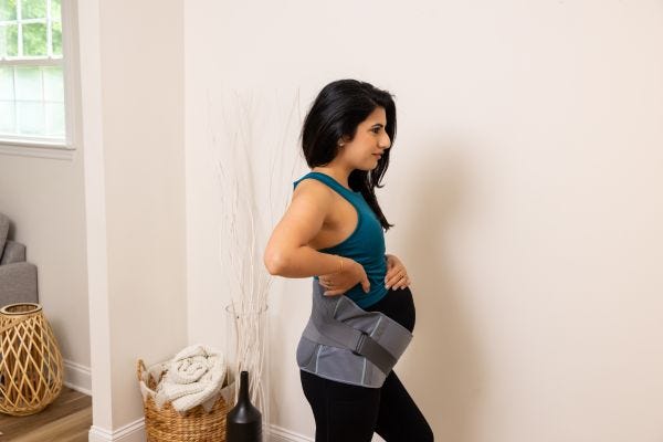 pregnant mom wearing Motif Medical's Lumbar Support Pro