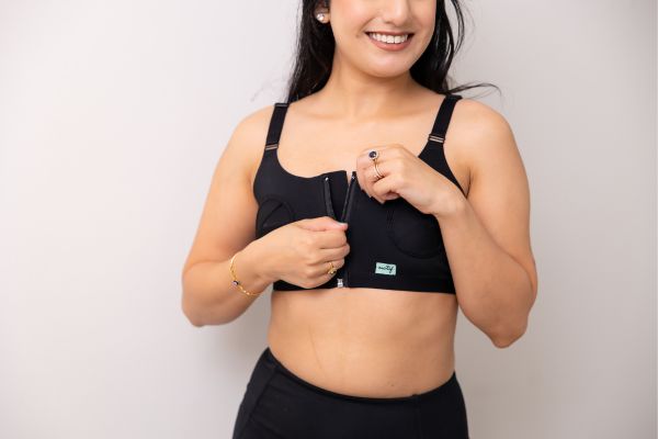 Mom wearing Motif Medical's Hands-free Pumping Bra