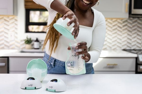 Breastfeeding mom using Motif Aura Glow™ Wearable Breast Pump