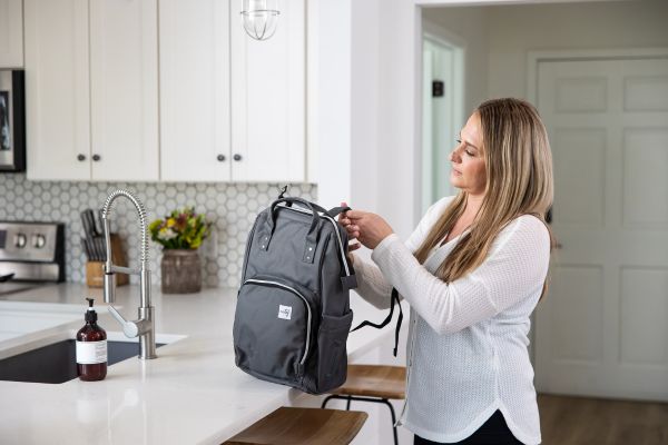 Mom packing her breast pump backpack 
