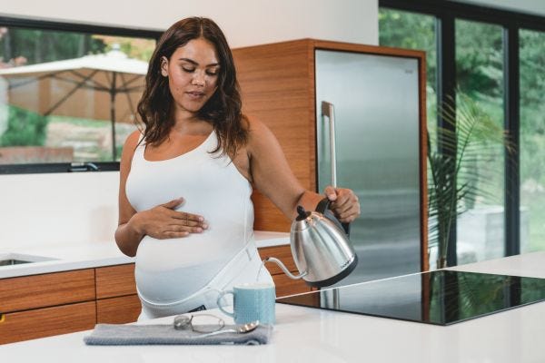 pregnant mom wearing Motif Medical's pregnancy support backbrace
