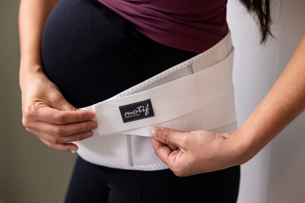 pregnant mom wearing motif medical's pregnancy back brace
