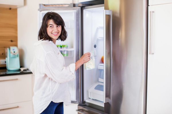 Mom storing breastmilk in the fridge