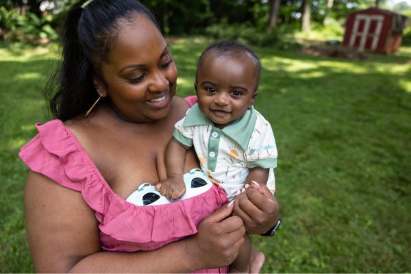 Breastfeeding mom wearing the motif aura glow breast pump