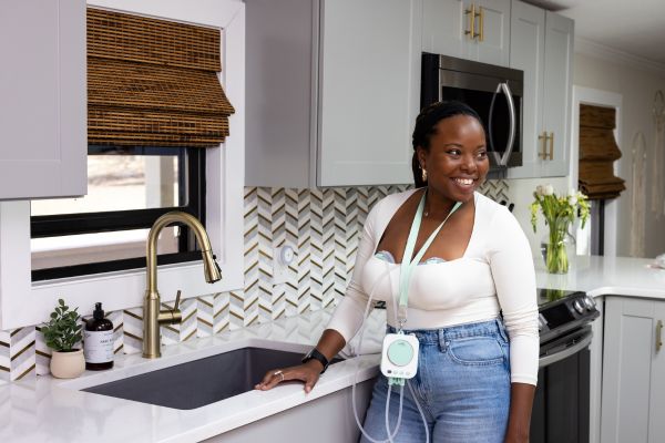 breastfeeding mom using the motif roam breast pump